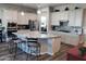 Spacious kitchen with granite countertops, white cabinets, a large island, and modern appliances at 42024 W Rosewood Ln, Maricopa, AZ 85138