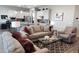 Inviting living room showcasing stylish furnishings, neutral tones, and an open concept layout to the kitchen at 42024 W Rosewood Ln, Maricopa, AZ 85138