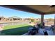 Covered patio featuring outdoor seating and picturesque water views at 42024 W Rosewood Ln, Maricopa, AZ 85138