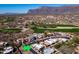 Aerial view of a Southwestern-style neighborhood, golf course, and surrounding desert landscape at 4309 S Priceless View Dr, Gold Canyon, AZ 85118