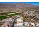 Stunning aerial view of a desert golf community nestled against picturesque mountains and desert landscape at 4309 S Priceless View Dr, Gold Canyon, AZ 85118