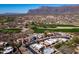 Expansive aerial shot showcasing a residential area with a golf course and mountain backdrop at 4309 S Priceless View Dr, Gold Canyon, AZ 85118