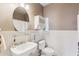 Cozy bathroom features a pedestal sink, oval mirror, and modern fixtures at 4309 S Priceless View Dr, Gold Canyon, AZ 85118