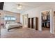 Inviting bedroom featuring a large window, ceiling fan, and walk-in closet at 4309 S Priceless View Dr, Gold Canyon, AZ 85118