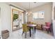 Bright dining area features a chandelier, wood table with chairs, and access to the outdoor patio at 4309 S Priceless View Dr, Gold Canyon, AZ 85118