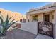 Southwestern-style home featuring desert landscaping, decorative metal gate, and covered entry at 4309 S Priceless View Dr, Gold Canyon, AZ 85118