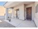 Covered front porch with decorative iron door, desert plants, and gravel landscaping at 4309 S Priceless View Dr, Gold Canyon, AZ 85118