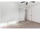 Bedroom with neutral carpet, ceiling fan, and closet with louvered doors at 4341 W Ocotillo Rd, Glendale, AZ 85301