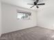 Bright bedroom with neutral carpet, window, and a ceiling fan at 4341 W Ocotillo Rd, Glendale, AZ 85301