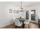 Modern dining area featuring a round table, white chairs, and a contemporary chandelier at 4341 W Ocotillo Rd, Glendale, AZ 85301