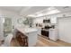 Modern, all-white kitchen with stainless steel appliances, breakfast bar and sleek countertops at 4341 W Ocotillo Rd, Glendale, AZ 85301