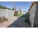 Landscaped backyard with a mix of greenery, rocks, and hardscaping elements at 4428 W Mission Ln, Glendale, AZ 85302