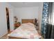 Simple bedroom featuring a bed, closet, and light airy drapes at 4428 W Mission Ln, Glendale, AZ 85302