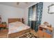 Cozy bedroom featuring a wooden bed frame, and a ceiling fan at 4428 W Mission Ln, Glendale, AZ 85302