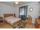 Bright bedroom with a wooden bed frame, and a ceiling fan at 4428 W Mission Ln, Glendale, AZ 85302