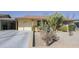 Landscaped front yard of a home featuring native cacti and xeriscaping for low maintenance at 4428 W Mission Ln, Glendale, AZ 85302