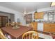 Bright kitchen with wood cabinets, dining table, and modern appliances at 4428 W Mission Ln, Glendale, AZ 85302