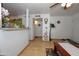 Spacious living room with wood laminate floors, ceiling fan, and view into other rooms at 4428 W Mission Ln, Glendale, AZ 85302