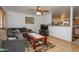 Comfortable living room with ceiling fan, wood laminate flooring, large sofa, and neutral paint at 4428 W Mission Ln, Glendale, AZ 85302