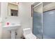 Classic bathroom with a pedestal sink, tiled shower, and blue accents at 4502 N 2Nd Dr, Phoenix, AZ 85013