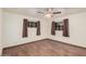 Spacious bedroom with wood floors, two windows, and a ceiling fan at 4502 N 2Nd Dr, Phoenix, AZ 85013