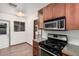 Well-equipped kitchen featuring stainless steel appliances, wood cabinets, and a gas range at 4502 N 2Nd Dr, Phoenix, AZ 85013