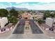 Aerial view of the community entrance with clubhouse, landscaping, and mountain views at 455 S Delaware Dr # 106, Apache Junction, AZ 85120