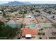 Aerial view of a community with pool, tennis courts and mountains in the background, showcasing its amenities at 455 S Delaware Dr # 106, Apache Junction, AZ 85120