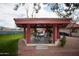 View of a lovely red roofed gazebo with table and chairs on community property at 455 S Delaware Dr # 106, Apache Junction, AZ 85120