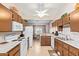 Functional kitchen with white appliances, neutral countertops, and tile flooring at 455 S Delaware Dr # 106, Apache Junction, AZ 85120