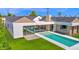 Sprawling modern home featuring a backyard oasis with a pool and lush green lawn at 4704 N 40Th Pl, Phoenix, AZ 85018