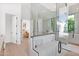 Modern bathroom with a walk-in glass shower, wood cabinet vanity, and updated fixtures at 4704 N 40Th Pl, Phoenix, AZ 85018