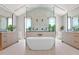 Luxurious bathroom featuring a soaking tub, dual vanities, and a glass-enclosed shower at 4704 N 40Th Pl, Phoenix, AZ 85018