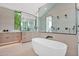 Elegant bathroom with a standalone tub, wood vanity, and a glass-enclosed shower at 4704 N 40Th Pl, Phoenix, AZ 85018