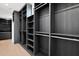 Walk-in closet with dark wood shelving and ample storage space for clothes and accessories at 4704 N 40Th Pl, Phoenix, AZ 85018