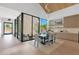 Elegant dining area featuring modern lighting, a glass-enclosed courtyard, and adjacent custom cabinetry at 4704 N 40Th Pl, Phoenix, AZ 85018