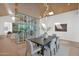 Dining room with modern lighting and a unique glass-enclosed wine storage feature at 4704 N 40Th Pl, Phoenix, AZ 85018