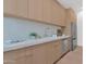 Modern kitchen with light wood cabinets, white countertops, and stainless steel appliances at 4704 N 40Th Pl, Phoenix, AZ 85018