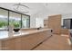 Modern kitchen with a long island counter, and view to the backyard swimming pool area at 4704 N 40Th Pl, Phoenix, AZ 85018