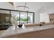 Bright, modern kitchen featuring an island with stone countertop and views of the backyard, pool, and outdoor seating at 4704 N 40Th Pl, Phoenix, AZ 85018