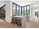 Kitchen with seamless indoor-outdoor flow, featuring a bar area with modern stools and abundant natural light at 4704 N 40Th Pl, Phoenix, AZ 85018