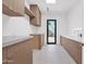 Well-organized laundry room with ample cabinet space and a convenient folding area at 4704 N 40Th Pl, Phoenix, AZ 85018