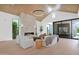 Cozy living room with a stone fireplace, modern lighting, and floor-to-ceiling windows at 4704 N 40Th Pl, Phoenix, AZ 85018