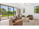 Sun-filled living room featuring modern furnishings and an expansive window overlooking the backyard at 4704 N 40Th Pl, Phoenix, AZ 85018