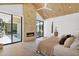 Cozy main bedroom with stone fireplace and sliding glass doors to outdoor pool area at 4704 N 40Th Pl, Phoenix, AZ 85018