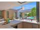 View of outdoor kitchen with high-end appliances and a view of the pool and patio area at 4704 N 40Th Pl, Phoenix, AZ 85018