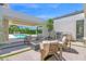 Inviting outdoor patio with comfortable seating, a modern fireplace, and a view of the pool at 4704 N 40Th Pl, Phoenix, AZ 85018