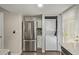 View of kitchen featuring stainless steel fridge, white cabinets and a stacked washer/dryer unit at 4842 E Kachina Trl # 3, Phoenix, AZ 85044