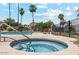 Community pool area with a spa surrounded by palm trees and blue skies at 4842 E Kachina Trl # 3, Phoenix, AZ 85044