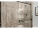 Close-up of a glass door shower with a tile surround, built in bench and a shower head at 4842 E Kachina Trl # 3, Phoenix, AZ 85044